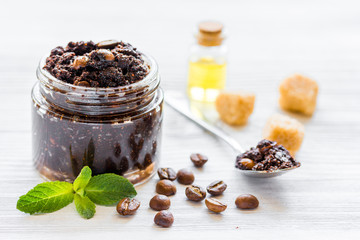 Spa concept with natural coffee scrub and oil on white background