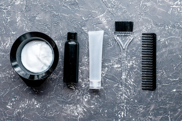 Tools for hair dye in barbershop on gray background top view