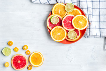 sliced citrus fruits on kitchen background top view mockup