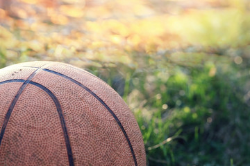 old basketball on grass background