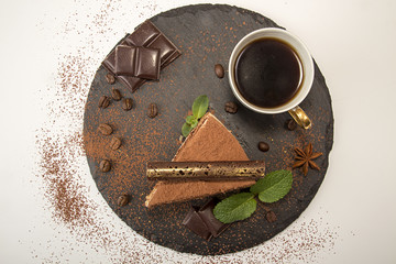 Piece of tiramisu cake on black slate