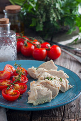 Dietary boiled chicken breast fillet with dumplings on a wooden table, selective focus