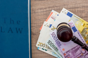 gavel and euros money on wooden table. close up.