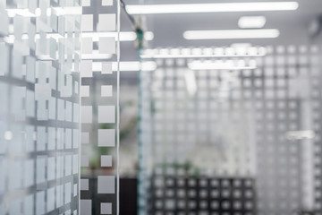 glass wall in office with modern pattern blurred background