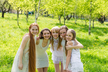 Fototapeta premium Five beautiful young girls in white dresses in summer