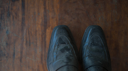 Old worn sneakers on a background of boards