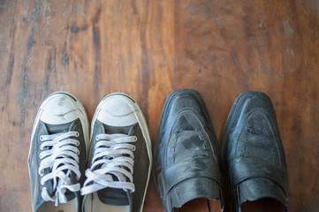 Old worn sneakers on a background of boards