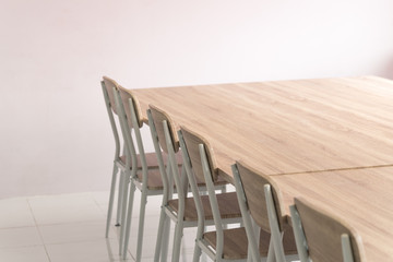 Empty rough wooden chairs and table in the conference room.