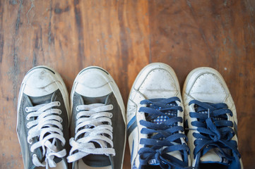 Old worn sneakers on a background of boards