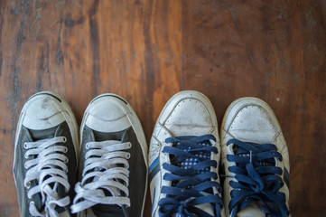 Old worn sneakers on a background of boards