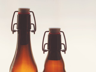 Two neck glass beer bottles on a white background
