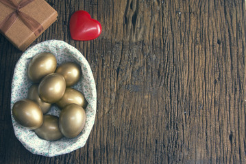golden eggs and easter prop on wood