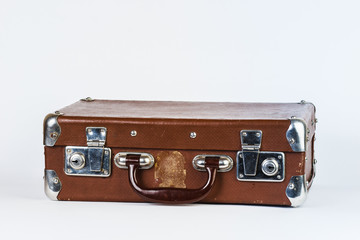 A brown suitcase. Vintage luggage. Vintage travel bag. Isolated on white background.