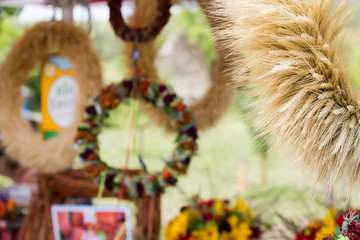 Wreaths of flowers and corn stalks in sales stall