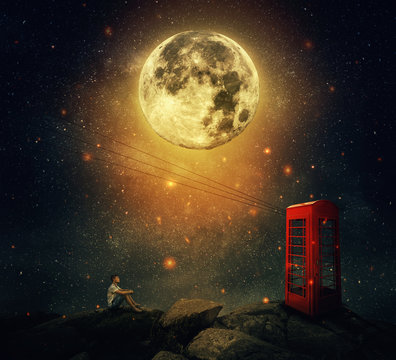 Imaginary view as a young man sitting on the cliff, wait for someone to call him at the phone booth (box). Full moon night with a starry sky background. Loyalty and hard determination concept.