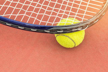 Tennis Ball with Racket on the clay tennis court, top view