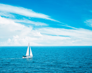 Beautiful Seascape with White Yacht Sailing in Blue Sea. Clouds on the Bakground. Toned Photo with...