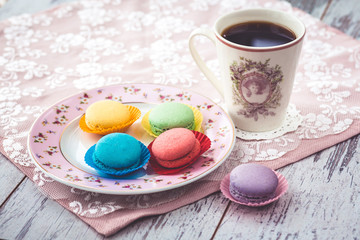  macaroon cookies on plate on wooden gray table