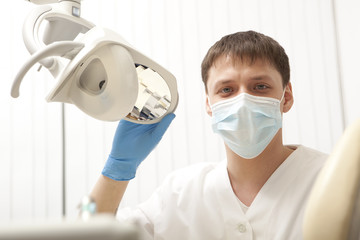 Fototapeta na wymiar Stomatology concept - happy male dentist at dental clinic office