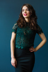 Cute young woman on dark blue background