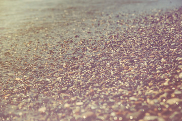 Close up of a pebble beach with the sea.