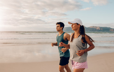 Young man and woman jogging in morning
