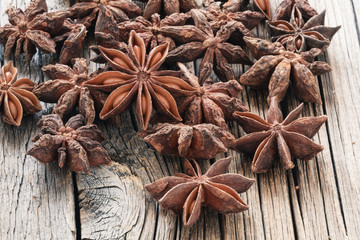 dried Anise seeds on wooden table close up