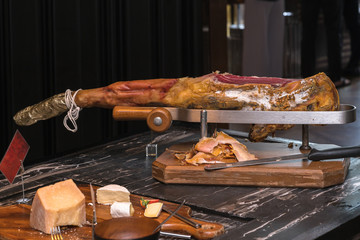 whole serrano ham leg over wood