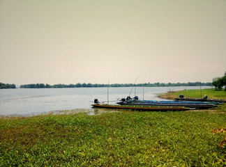 .Long-tailed boats waiting for fishing beside the river
