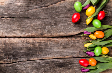 Easter eggs on wooden background. Spring concept on plank. Color mix eggs with nature decoration. 