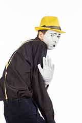 Portrait of a man, pantomime in confusion, showing that he is afraid. Isolated on white background.