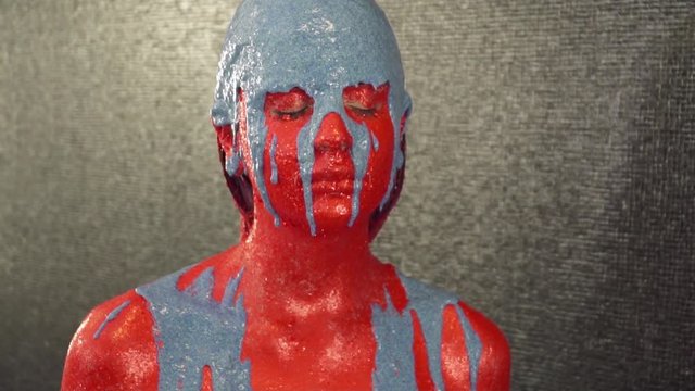 The blue color is pouring down the girl's face and body slow motion