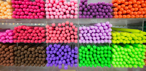 Multicolored pens on shelves