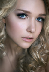 portrait of beautiful young blonde girl who looks in the frame