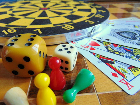 dart- on chessboard with cards and dice next to it