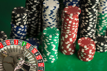 Casino theme. casino roulette, poker game, dice game, poker chips on a gaming table,  Place for typography and logo.