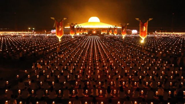 Thousands of people take part in evening prayers to mark Makha Bucha Day at Wat Dhammakaya temple in Thailand.