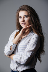 Portrait of a fashionable dreamy young brunette beauty.