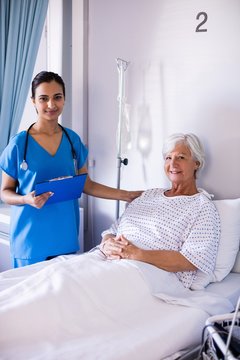 Female doctor and senior patient smiling