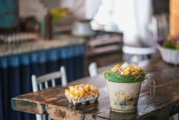 The loft-house is decorated for Easter. Easter decor home. Festive mood in a beautiful house with greenery, colorful eggs, garland.