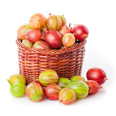 gooseberries in a wooden bowl. Gooseberries fresh berries. red green gooseberry on white