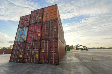 a pile of container in freight yard against a blue sky, transport background