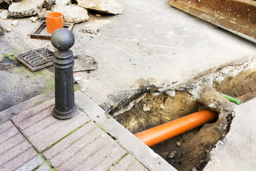 construction worker repair sewer  pipes in street city