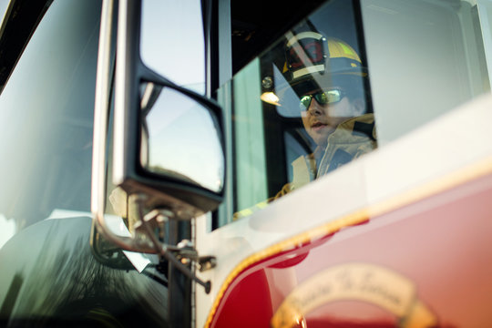Firefighter driving fire truck