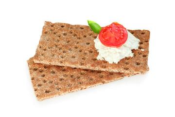 Crispbread with soft cottage cheese and red tomato slices. Isolated on white background