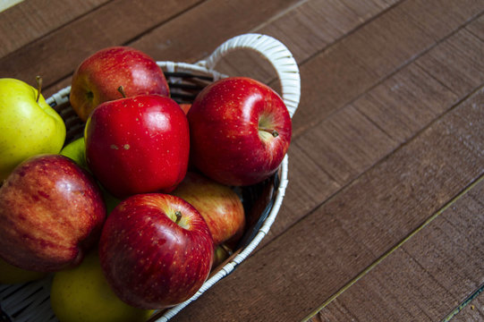Basket in red apples, basket full of apples, apples pictures on authentic wood floor,
