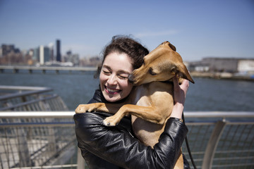 Smiling woman hugging dog