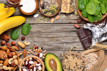 Healthy food, products containing magnesium on wooden background. Copyspace background.Top view. - obrazy, fototapety, plakaty