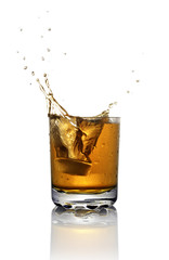 Splash in glass of scotch whiskey with ice