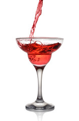 Splash in glass of a pink alcoholic cocktail drink